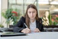 Blurred business woman working with the documents having cup of coffee at cafe with copy space Royalty Free Stock Photo