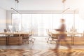 Blurred businessman wearing formal suit is walking inside office