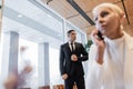 blurred businesswoman talking on smartphone near