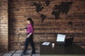 Blurred businesswoman walking to her desk