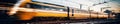Blurred capture of a modern train powering through a station. Created by AI