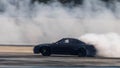 Blurred car drifting diffusion race drift car with lots of smoke from burning tires on speed track, Professional driver drifting Royalty Free Stock Photo