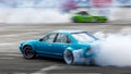 Blurred car drifting, Two car drifting battle on asphalt street road race track, Automobile and automotive drift car with smoke Royalty Free Stock Photo