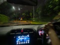 Blurred car driver view seeing a road turn warning sign during the rain at night Royalty Free Stock Photo