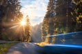 Blurred car is driving fast on mountain road in the autumn forest in the evening Travel by car concept Royalty Free Stock Photo