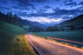 Blurred car headlights on rural road at night in summer Royalty Free Stock Photo