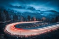 Blurred car headlights on winding road in mountains Royalty Free Stock Photo