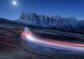 Blurred car headlights on winding road at night Royalty Free Stock Photo