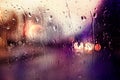 Blurred car lights. Raindrops on the window Royalty Free Stock Photo