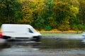 Blurred car in motion on wet road Royalty Free Stock Photo