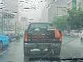 Blurred car on road in raining, driver view Royalty Free Stock Photo
