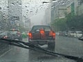 Blurred car on road in raining, driver view Royalty Free Stock Photo
