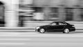 Blurred car speeding on the city road. Royalty Free Stock Photo