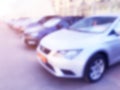 Blurred cars in car parking lot in shopping mall. Bokeh lights background. Abstract blur car parking lot for background. Blurred c Royalty Free Stock Photo