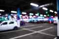 Blurred cars in car parking lot in shopping mall. Bokeh lights background. Abstract blur car parking lot for background. Blurred c Royalty Free Stock Photo