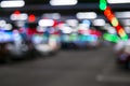 Blurred cars in car parking lot in shopping mall. Bokeh lights background. Abstract blur car parking lot for background. Blurred c Royalty Free Stock Photo