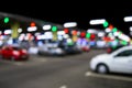 Blurred cars in car parking lot in shopping mall. Bokeh lights background. Abstract blur car parking lot for background. Blurred c Royalty Free Stock Photo