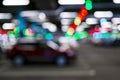 Blurred cars in car parking lot in shopping mall. Bokeh lights background. Abstract blur car parking lot for background. Blurred c Royalty Free Stock Photo