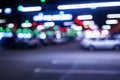 Blurred cars in car parking lot in shopping mall. Bokeh lights background. Abstract blur car parking lot for background. Blurred c Royalty Free Stock Photo