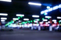 Blurred cars in car parking lot in shopping mall. Bokeh lights background. Abstract blur car parking lot for background. Blurred c Royalty Free Stock Photo