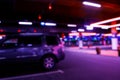 Blurred cars in car parking lot in shopping mall. Bokeh lights background. Abstract blur car parking lot for background. Blurred c Royalty Free Stock Photo