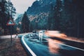 Blurred cars in motion on the road in autumn forest in rain Royalty Free Stock Photo