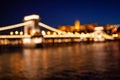 Blurred chain bridge in Budapest at night. Hungarian landmarks