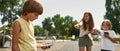 Blurred children laughing from boy with old phone Royalty Free Stock Photo