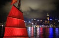 Chinese red junk with the victoria harbor night view background Royalty Free Stock Photo