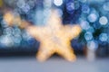 Blurred Christmas background. Gold star and blue blurry lighting Royalty Free Stock Photo