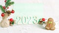 Blurred Christmas celebration. Number 2023 with lights. Xmas holiday composition.