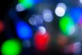 Blurred christmas lights dark blue, white, red, pink, green background. Abstract bokeh with soft light. Shiny festive texture Royalty Free Stock Photo