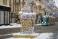 Blurred Christmas lights with famous Clock Tower on Herrengasse street in the city center of Graz, Steiermark, Austria, in snowy