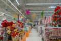 Blurred Christmas supermarket. Sale of festive Christmas accessories and trees in a retail store. Royalty Free Stock Photo