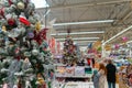 Sale of festive Christmas accessories and trees in a retail store. Blurred background in the store Royalty Free Stock Photo