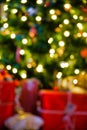 Blurred christmas themed background, christmas tree, presents and lights Royalty Free Stock Photo