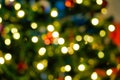 Blurred christmas themed background, christmas tree, presents and lights Royalty Free Stock Photo