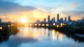 Blurred city skyline at sunset with reflections on river Royalty Free Stock Photo
