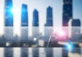 Blurred Cityscape with Lens Flares and Reflective Surface Royalty Free Stock Photo