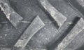 Blurred close up photo of a tractor tire tread, industrial background