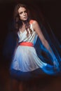 Blurred color art portrait of a girl on a dark background. Fashion woman with beautiful makeup and a light summer dress. Sensual Royalty Free Stock Photo