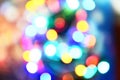 Blurred colorful bokeh and lights decorated christmas tree on black background for holidays festival celebration New Year Royalty Free Stock Photo