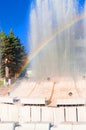 Blurred colorful rainbow on a background of splashing fountain on a Sunny summer day, vertical shot Royalty Free Stock Photo