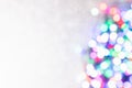 Blurred coloured confetti of lights on a sparkling white background with copy space Royalty Free Stock Photo