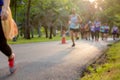 Blurred concept group of marathon people jogging in the park in morning.