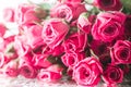 Blurred creative background of pink rose flowers. Partially defocused roses, on glossy surface with water drops Royalty Free Stock Photo