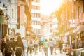 Blurred crowd of people on Copova pedestrian street in Ljubljana at sunset. Urban lifestyle and mobility concept.