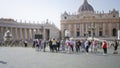 Blurred crowd standing in saint peter\'s basilica square with iconic vatican architecture forming a majestic backdrop under clear Royalty Free Stock Photo