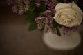 Blurred dark background image with artificial colors, right with a focus on the light rose