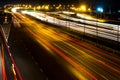 Blurred darknight traffic light trails on street. Royalty Free Stock Photo